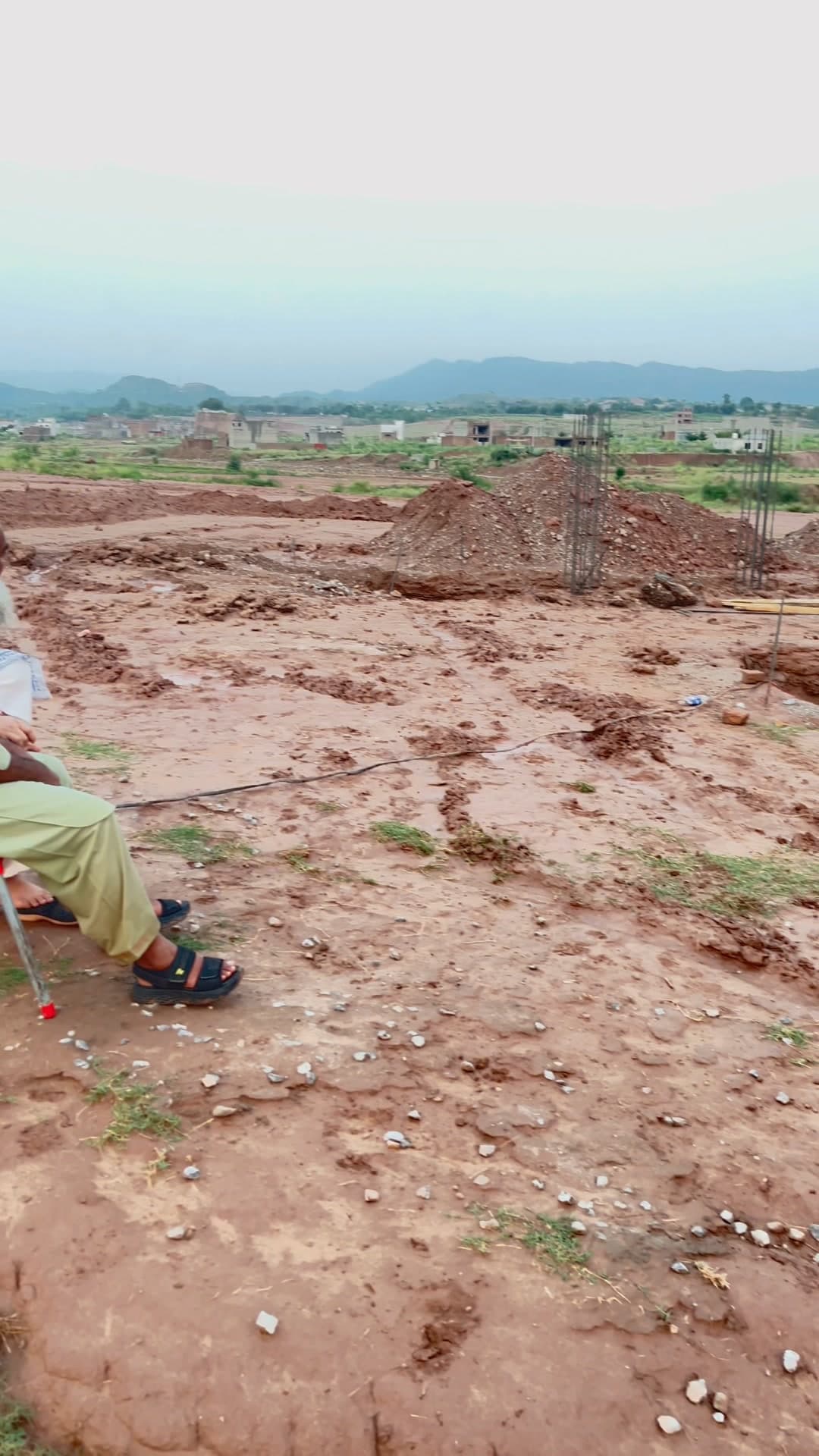 The Parsa Home plot in Islamabad, cleared and marked out, with the hills behind it.
